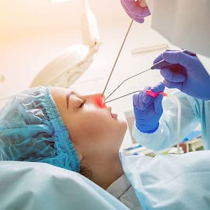 An ENT specialist using medical equipment.